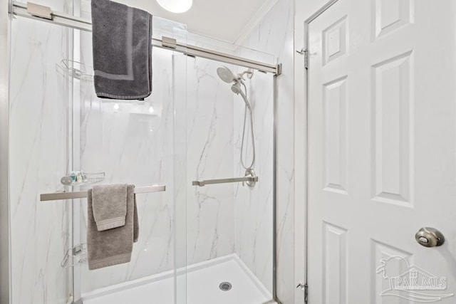 bathroom featuring a marble finish shower