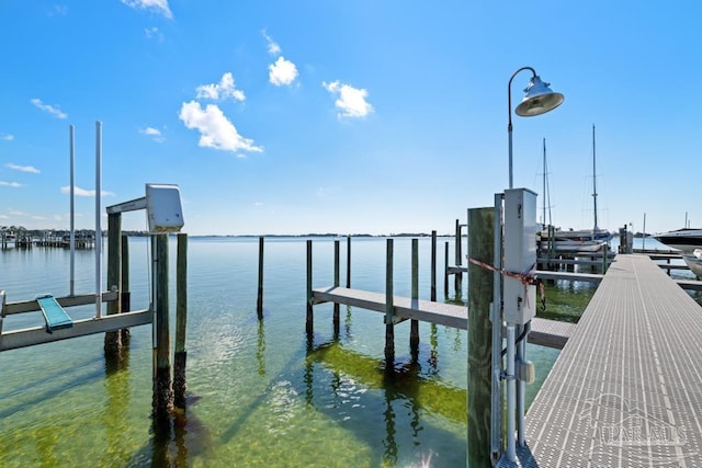 dock area with a water view and boat lift