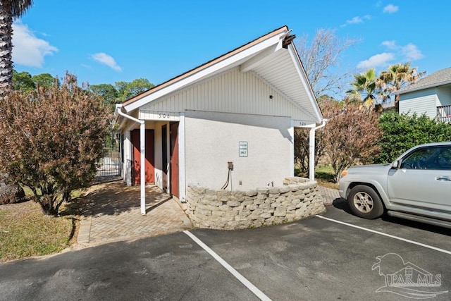 view of side of property with uncovered parking