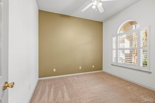 empty room featuring ceiling fan and light colored carpet