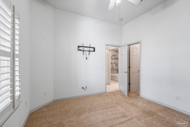 unfurnished room featuring ceiling fan and light colored carpet