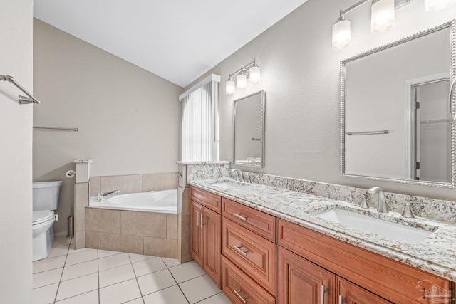 bathroom with vanity, lofted ceiling, tile patterned floors, a relaxing tiled tub, and toilet