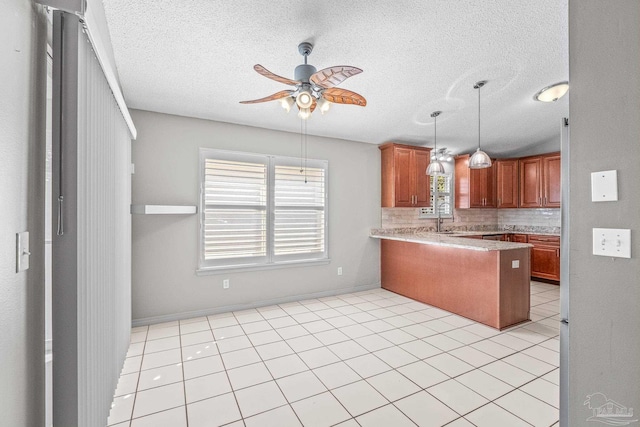 kitchen featuring kitchen peninsula, decorative backsplash, ceiling fan, and light tile patterned floors