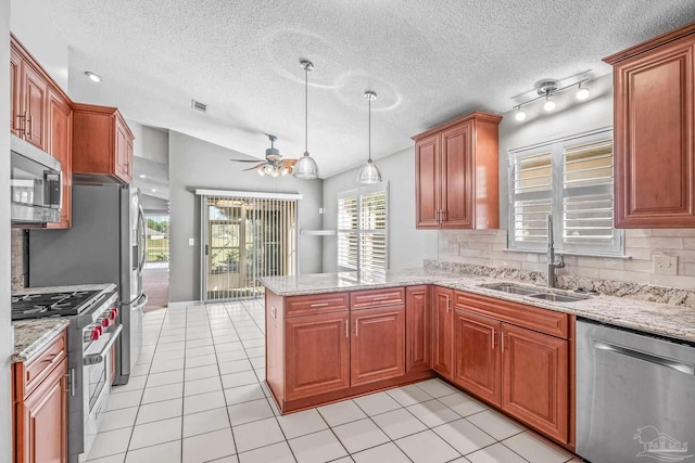 kitchen featuring backsplash, sink, ceiling fan, kitchen peninsula, and stainless steel appliances