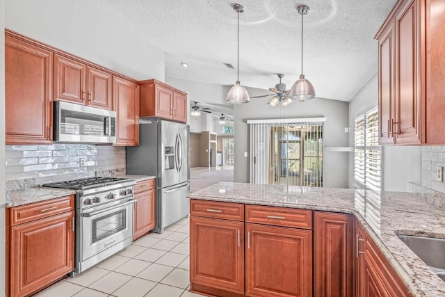 kitchen featuring tasteful backsplash, ceiling fan, pendant lighting, and stainless steel appliances