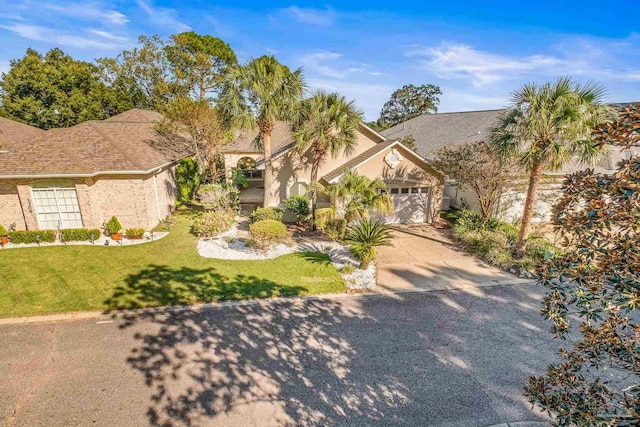 view of front of home featuring a front yard and a garage