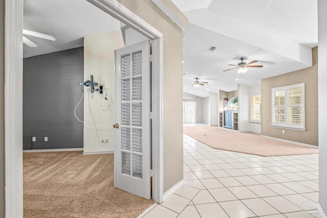 interior space featuring light colored carpet and a textured ceiling