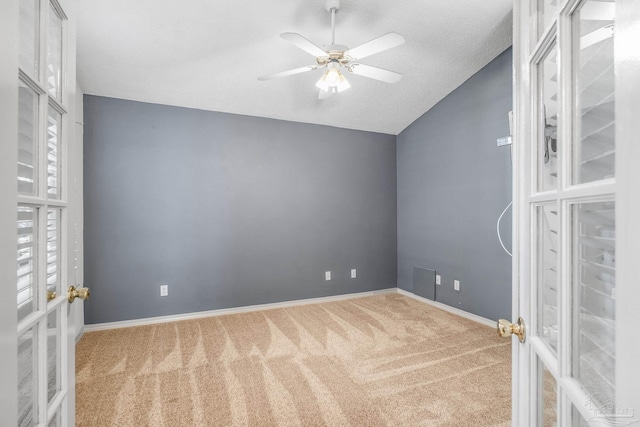 interior space with a textured ceiling, ceiling fan, lofted ceiling, and carpet floors