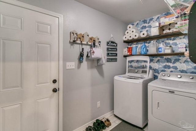 laundry area with laundry area, baseboards, and washing machine and dryer