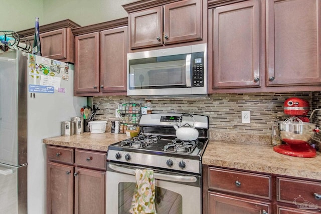 kitchen featuring light countertops, backsplash, and stainless steel appliances