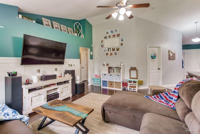 living room with a ceiling fan and high vaulted ceiling