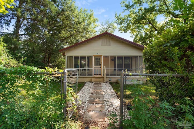 view of front of home featuring a sunroom