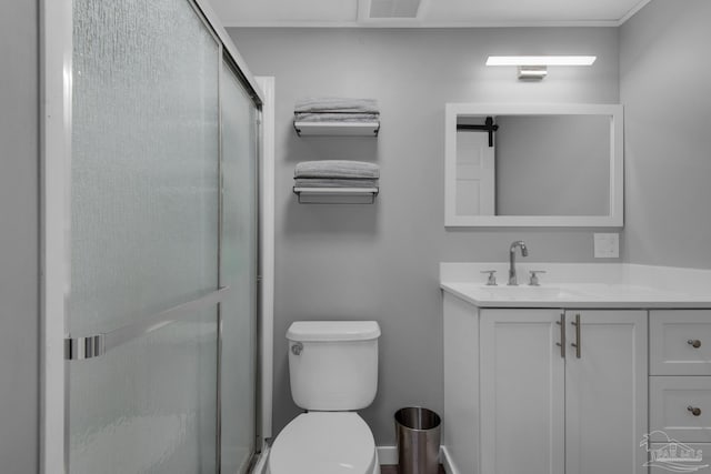 bathroom featuring an enclosed shower, vanity, and toilet