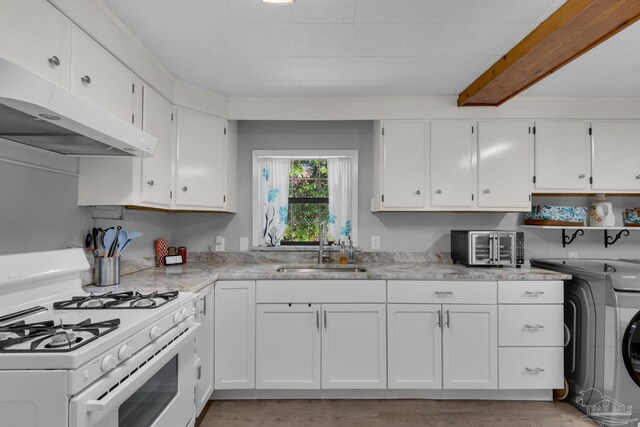 kitchen with light hardwood / wood-style floors, sink, gas range gas stove, and white cabinetry