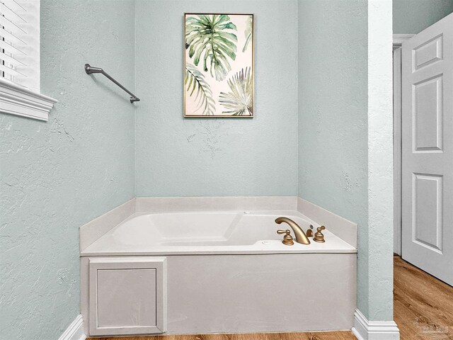 229 E Grand Key Loop, Destin, FL 32541 - bathroom with hardwood / wood-style floors and a bathtub