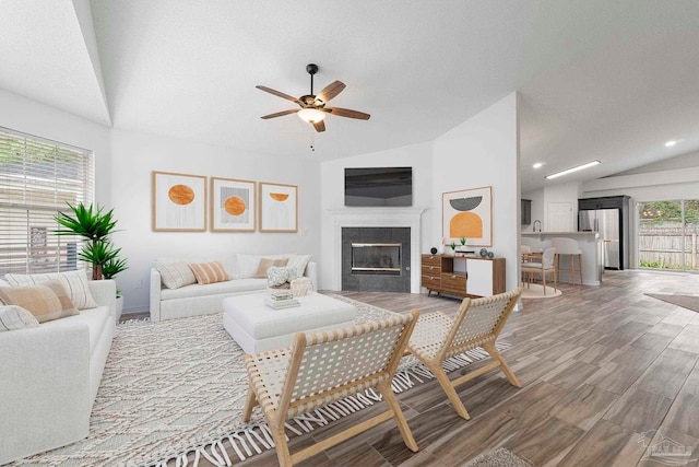 1042 Simpson St, Pensacola, FL 32526 - living area with lofted ceiling, a ceiling fan, a tile fireplace, wood finished floors, and recessed lighting