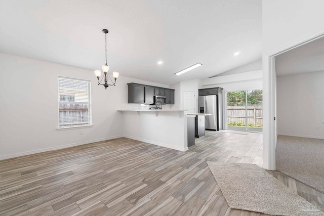 1042 Simpson St, Pensacola, FL 32526 - kitchen with appliances with stainless steel finishes, open floor plan, light countertops, a chandelier, and a peninsula