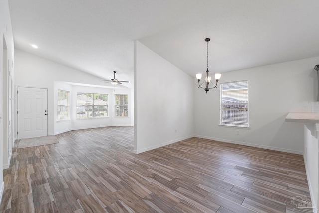 1042 Simpson St, Pensacola, FL 32526 - unfurnished dining area featuring vaulted ceiling, plenty of natural light, wood finished floors, a chandelier, and ceiling fan