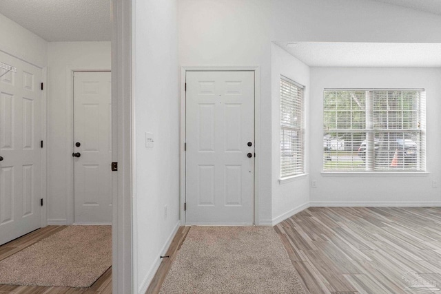 1042 Simpson St, Pensacola, FL 32526 - foyer entrance with light wood finished floors, baseboards, and a textured ceiling
