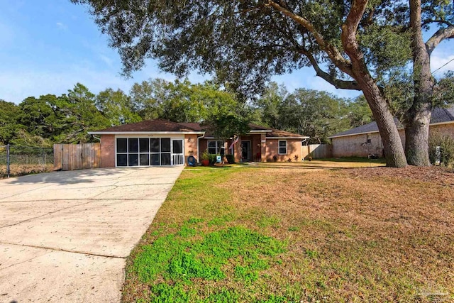 ranch-style house with a front yard and fence