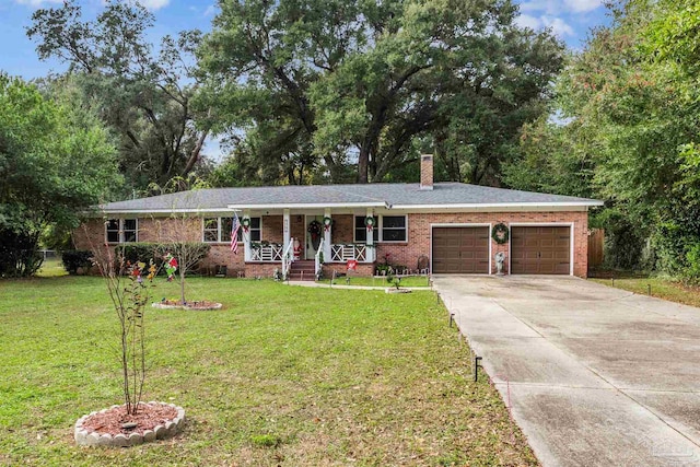 single story home with a porch, a garage, and a front yard