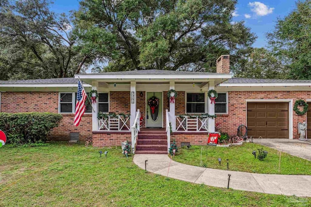 view of front of property featuring a porch, a front yard, and a garage