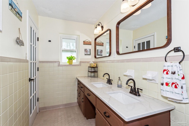 bathroom featuring tile patterned floors, vanity, and tile walls