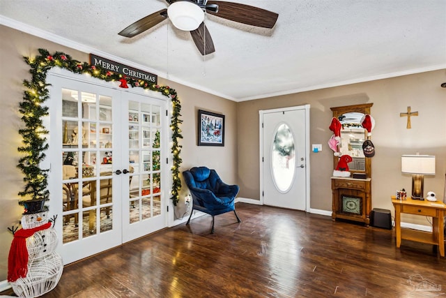 foyer entrance featuring ceiling fan, dark hardwood / wood-style flooring, a textured ceiling, and french doors