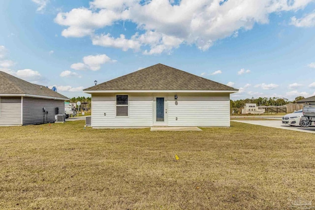 back of property featuring a yard and central air condition unit