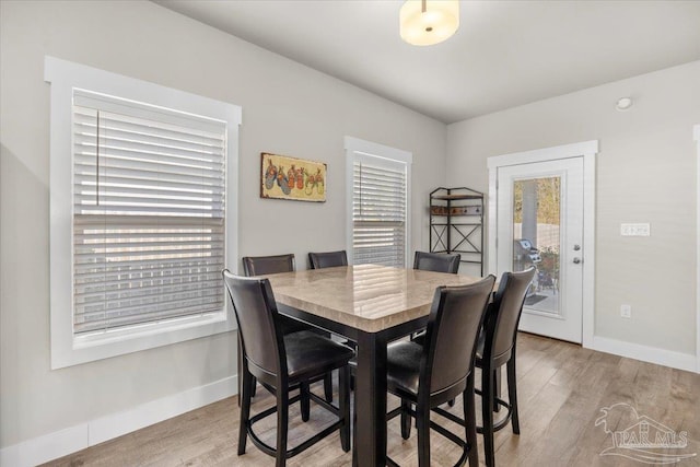 dining area featuring light hardwood / wood-style floors and plenty of natural light