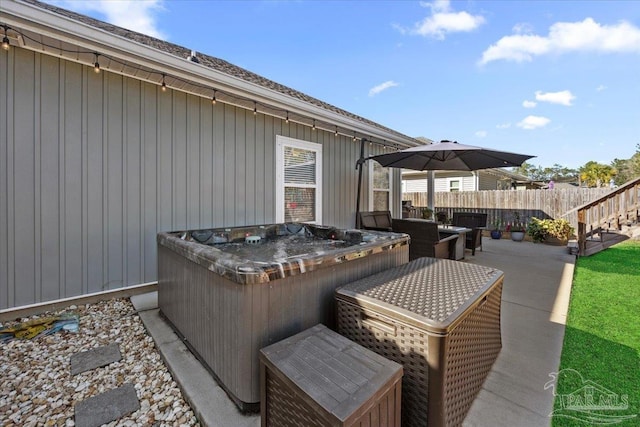 wooden terrace with a patio area and a hot tub