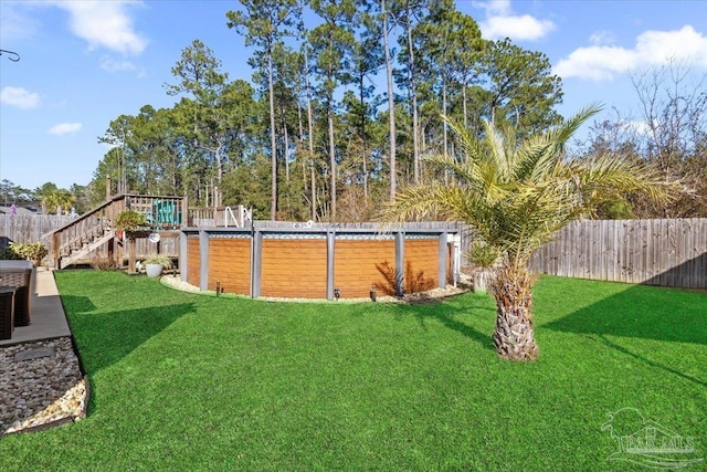 view of yard with a fenced in pool