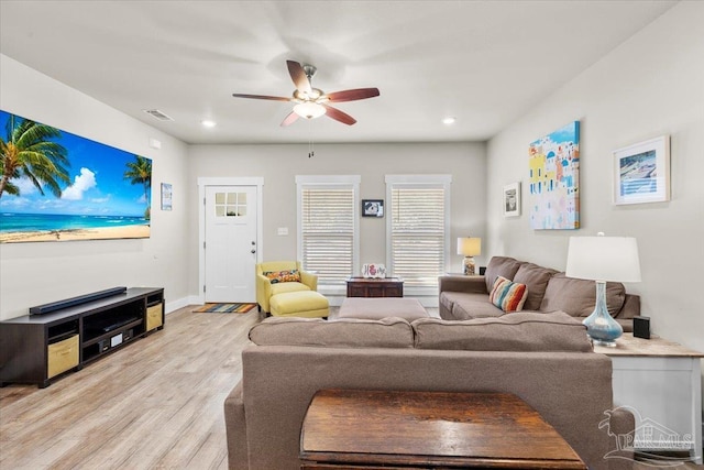 living room with ceiling fan and light hardwood / wood-style flooring