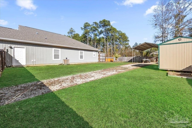 view of yard with a storage shed and a carport