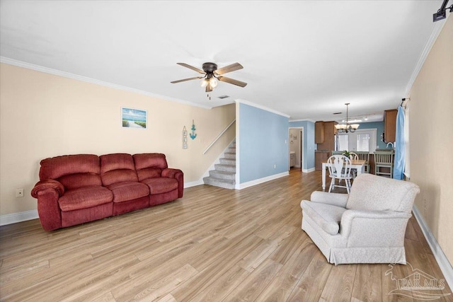 living room with ceiling fan with notable chandelier, light wood-type flooring, and ornamental molding