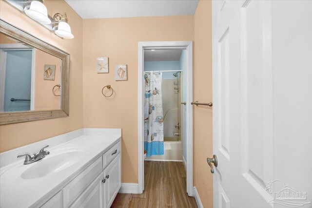 bathroom featuring vanity, shower / tub combo, and hardwood / wood-style flooring