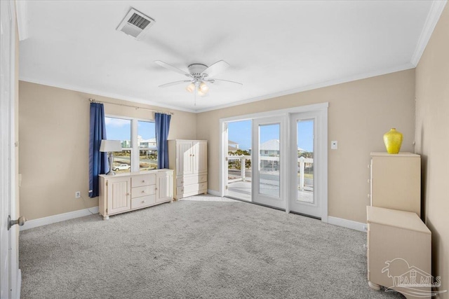 interior space featuring access to exterior, ceiling fan, light colored carpet, and ornamental molding