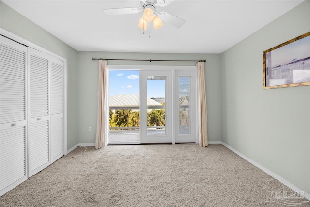 unfurnished bedroom featuring carpet floors, a closet, and ceiling fan