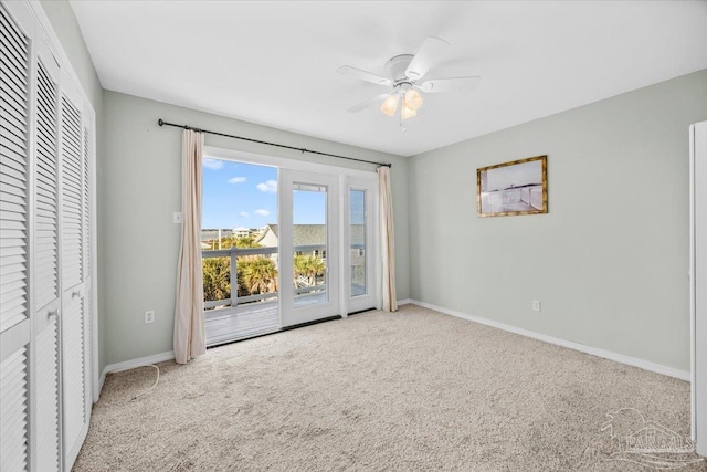 empty room with light colored carpet and ceiling fan