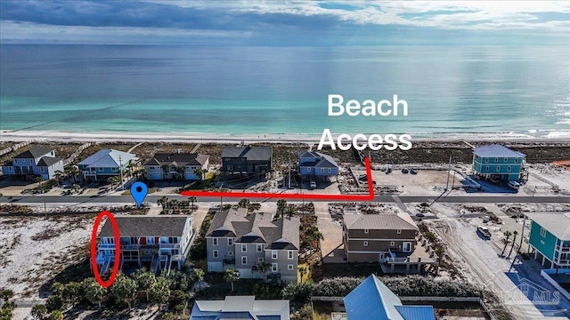 birds eye view of property featuring a view of the beach and a water view