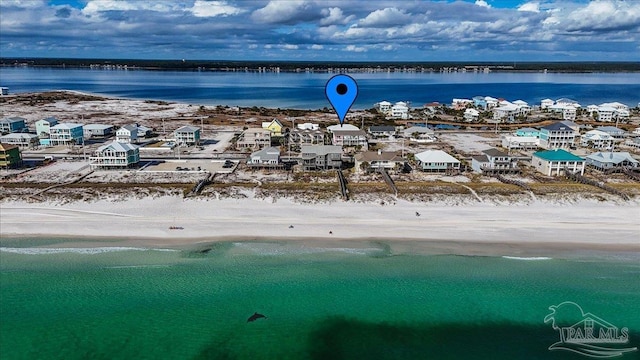 bird's eye view featuring a water view and a beach view