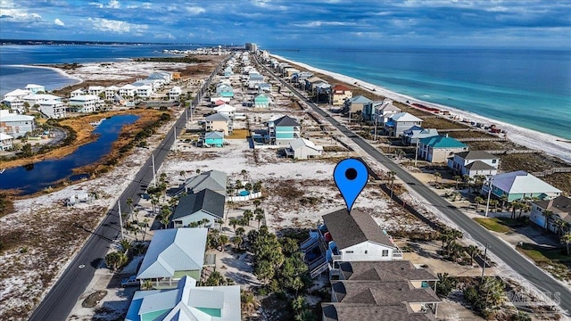 bird's eye view featuring a water view and a beach view