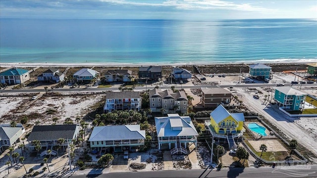 bird's eye view featuring a water view and a beach view