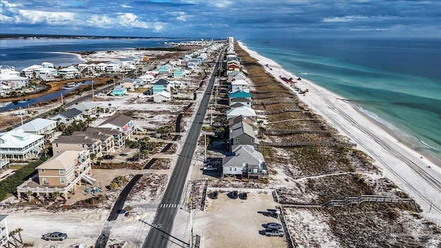 drone / aerial view featuring a water view and a view of the beach