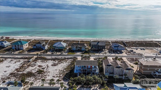 bird's eye view featuring a water view and a beach view