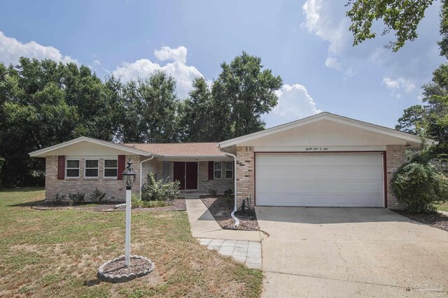 ranch-style house with a garage and a front yard