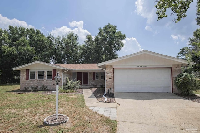 single story home featuring driveway, a front lawn, an attached garage, and brick siding