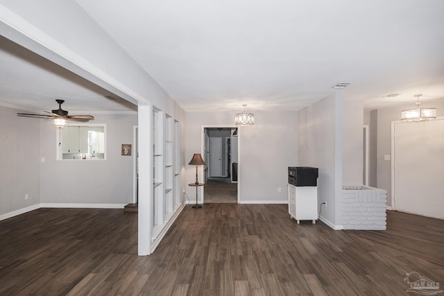 spare room featuring visible vents, dark wood finished floors, baseboards, and ceiling fan with notable chandelier