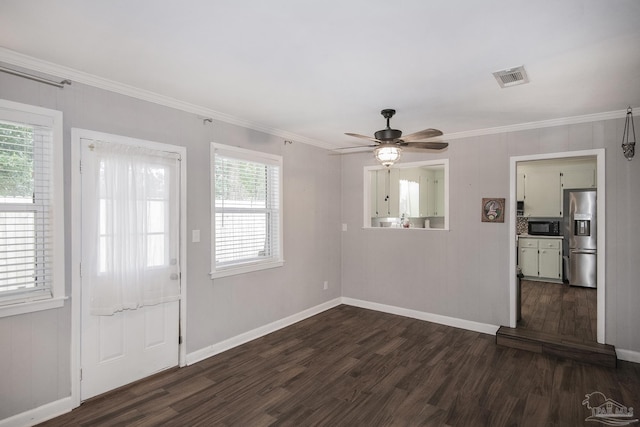 foyer with ornamental molding, ceiling fan, dark wood-type flooring, and visible vents