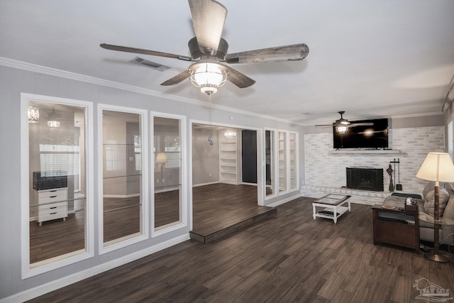 living room with a brick fireplace, visible vents, dark wood finished floors, and crown molding